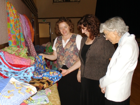 The Boulder Colorado Stake Relief Society made 215 quilts from mid-July through mid-September. On Sept. 27, 2008, Marita Reed (left), Terri Allred (center) and Velma Allred admire the quilts bound for the LDS Humanitarian Center in Salt Lake City to be used by disaster victims.