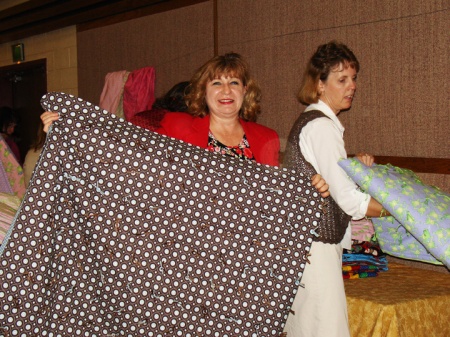 The Boulder Colorado Stake Relief Society made 215 quilts from mid-July through mid-September. On Sept. 27, 2008, Sylvia Robison (center) and Kelley Cook helped fold and pack quilts into boxes bound for the LDS Humanitarian Center in Salt Lake City to be used by disaster victims.
