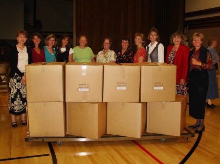 The Boulder Colorado Stake Relief Society made 215 quilts from mid-July through mid-September. On Sept. 27, 2008, (Left to right) Peggy Olson, Suzanne Davis, Marrlin Angus, Nancy Bradbury, Carolyn Thompson, Carolyn Loveday, Marie Alldredge, Karen Early, Kelley Cook, Sylvia Robison, and Angie Branch were among those who helped fold and pack quilts into boxes bound for the LDS Humanitarian Center in Salt Lake City to be used by disaster victims.